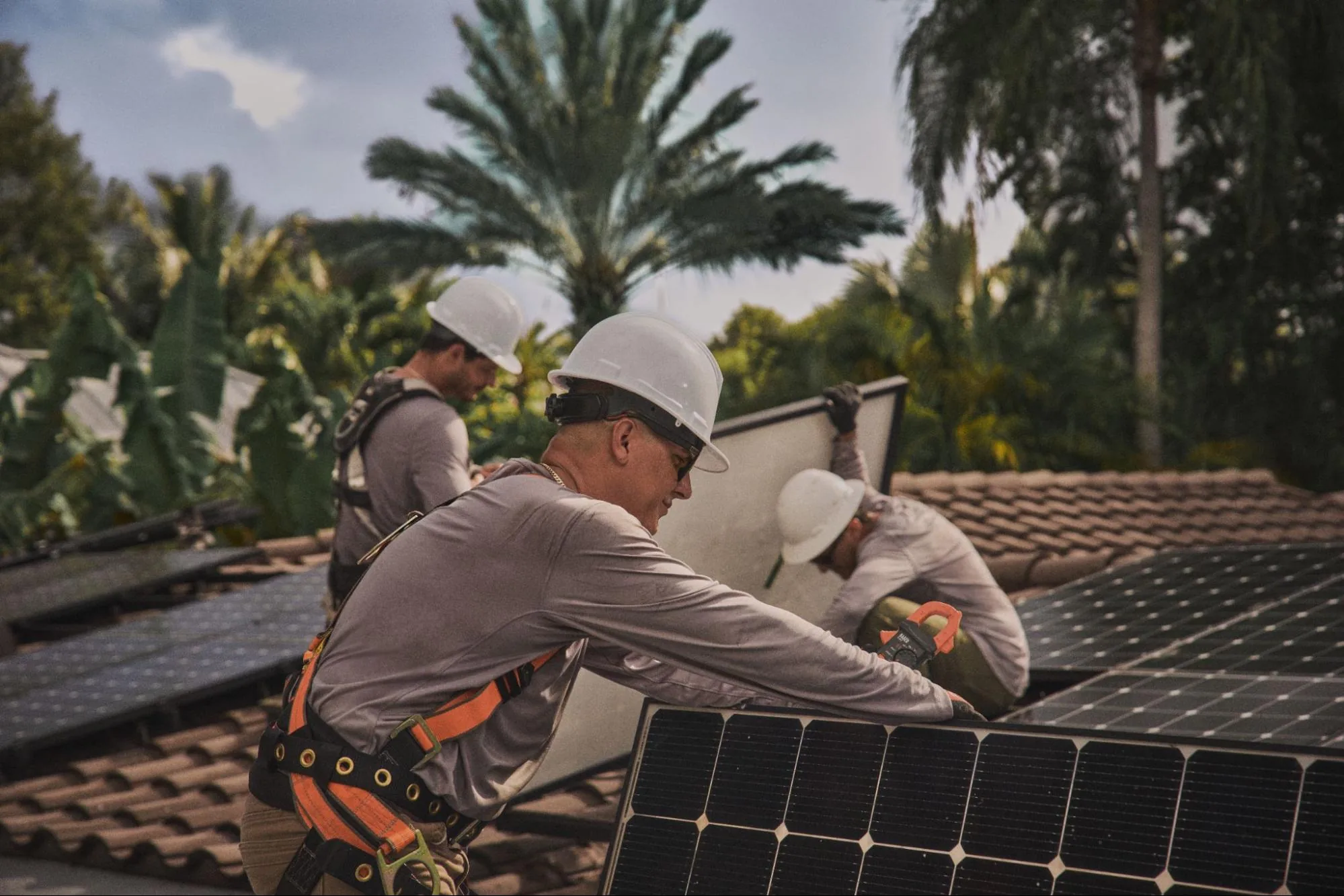 Licensed SolarSync pro working on a homeowner's rooftop solar panels